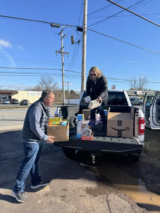 Blue Tree owners loading donated toys into a pickup truck.
